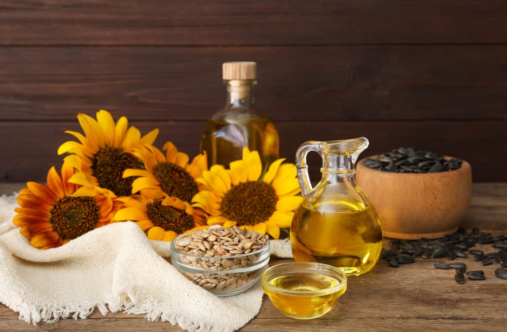 Composition with sunflower oil on wooden table