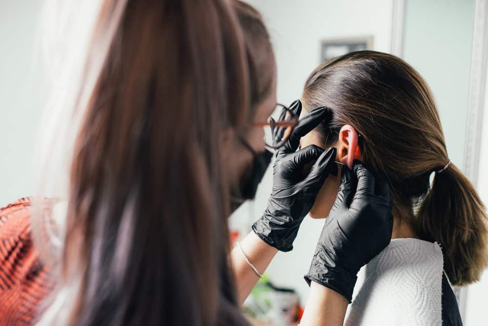 Ears piercing the girl