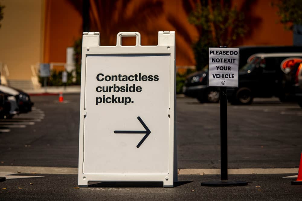 Sign advertising Contactless Curbside Pickup at retail store parking lot