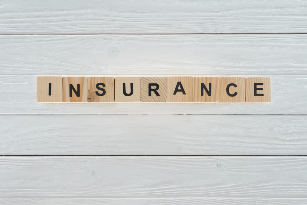 Top view of insurance word made of wooden blocks