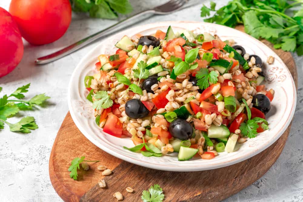 Pearl barley salad with vegetables in a plate